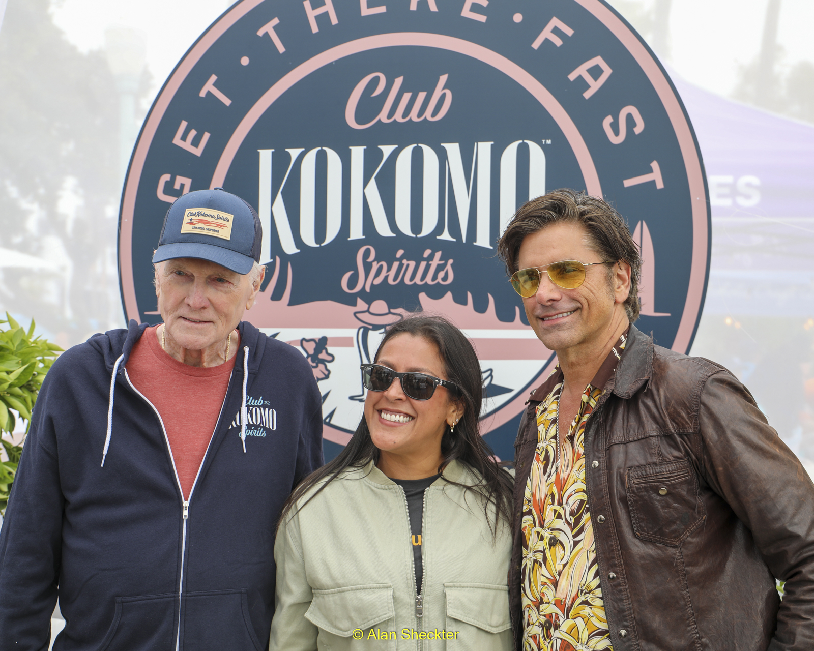 Mike Love and John Stamos with a fan